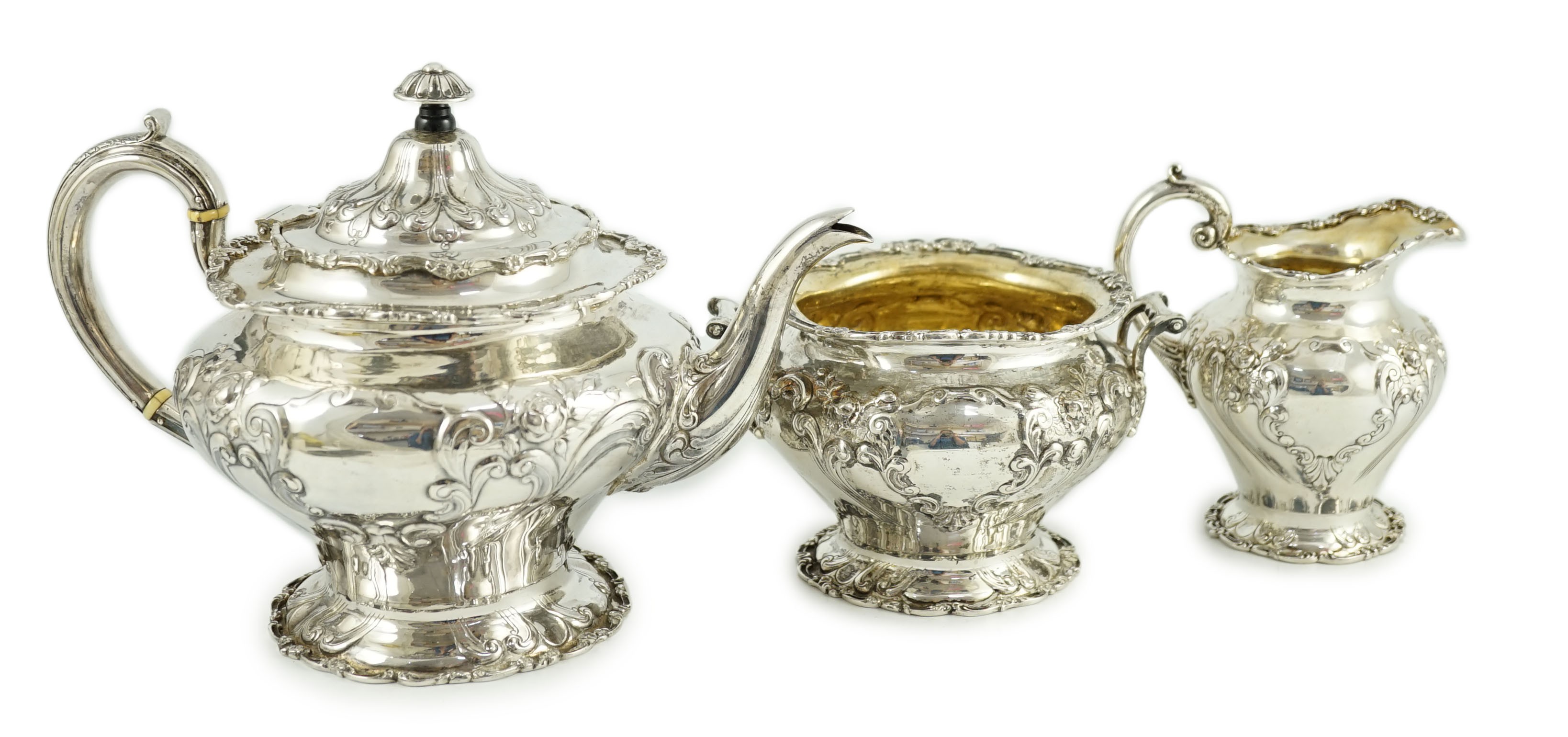 An Edwardian Scottish repousse silver three piece tea set, by Robert Scott